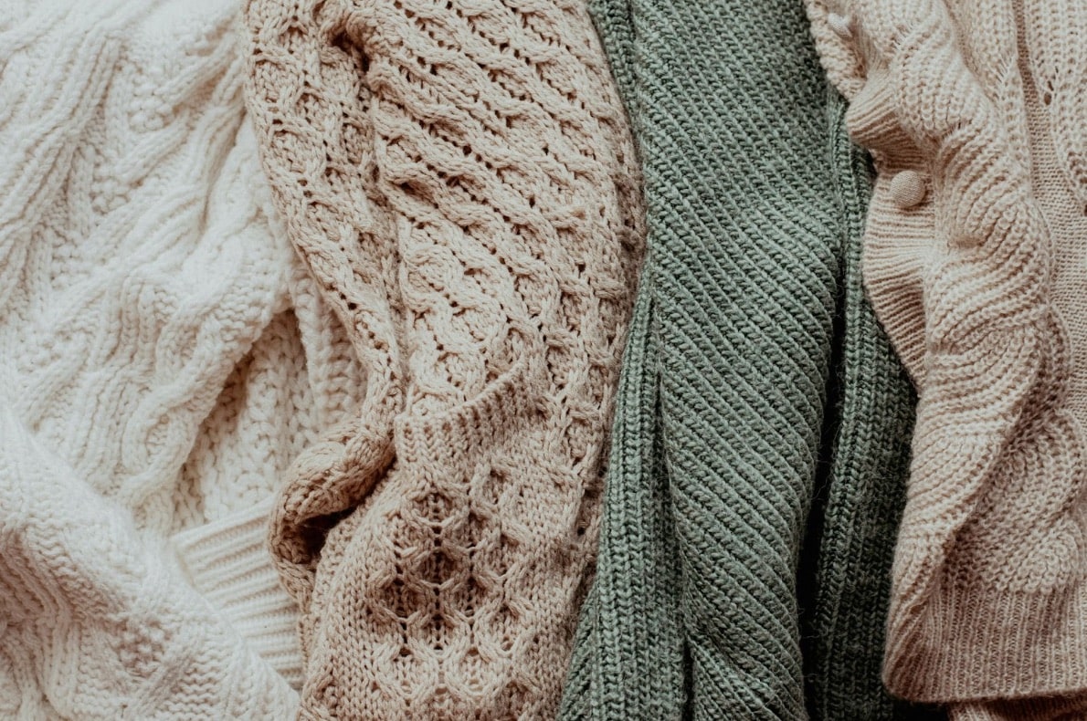 Wool sweaters with interwoven textures and natural colors